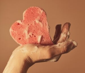 Heart-shaped sponge with soapy lather
