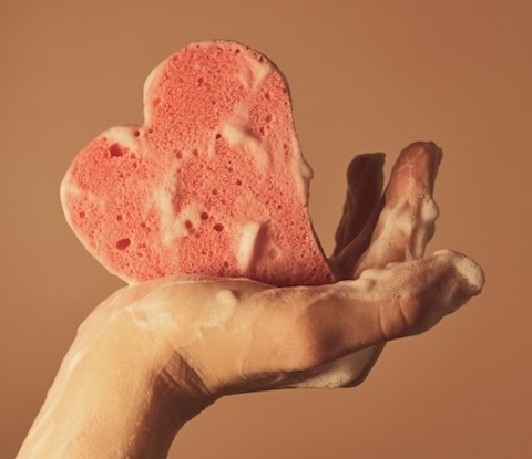 Heart-shaped sponge with soapy lather